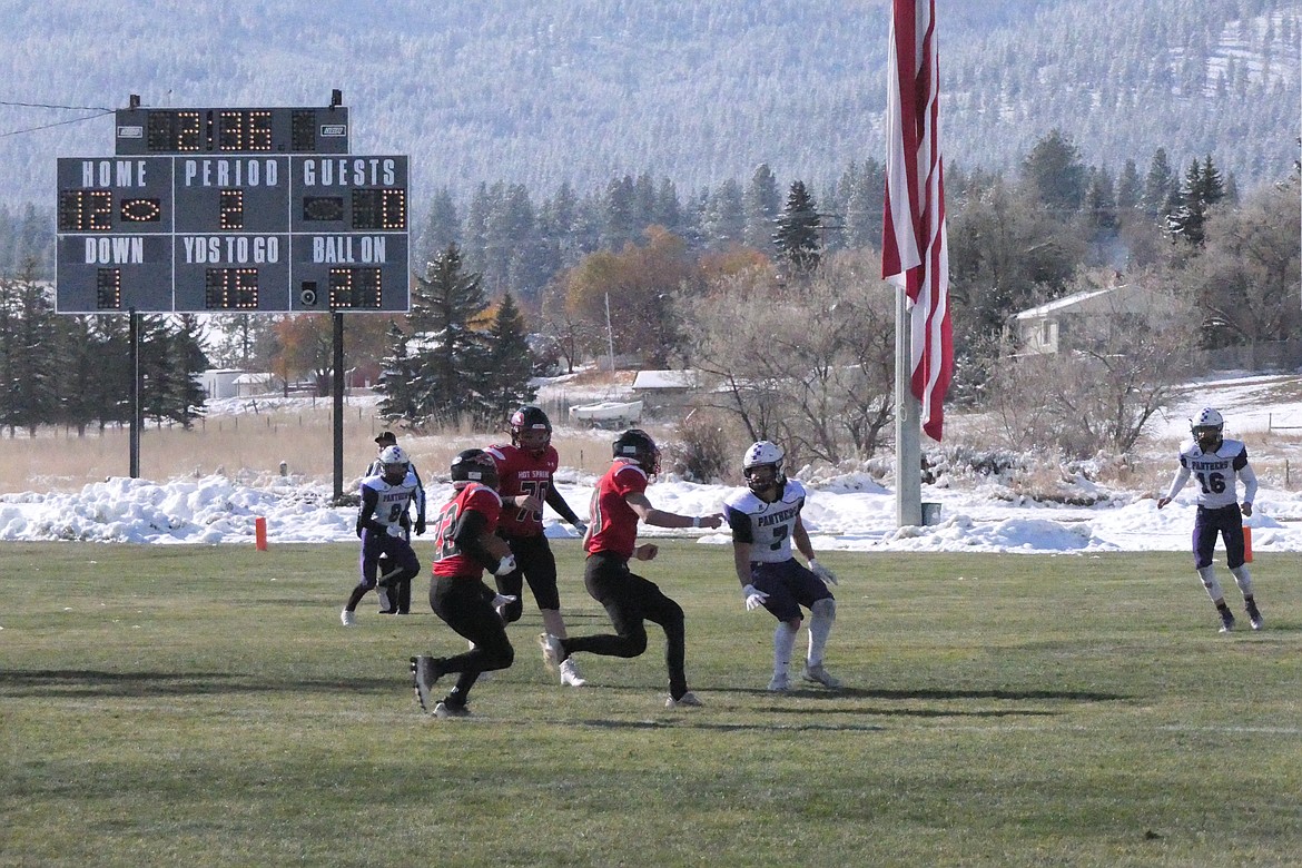 Hot Springs running back Weston Slonaker gets a block from Savage Heat QB Nick McAllister during the Heat's 40-6 first round playoff win over Valier Saturday in Hot Springs.  (Chuck Bandel/VP-MI)