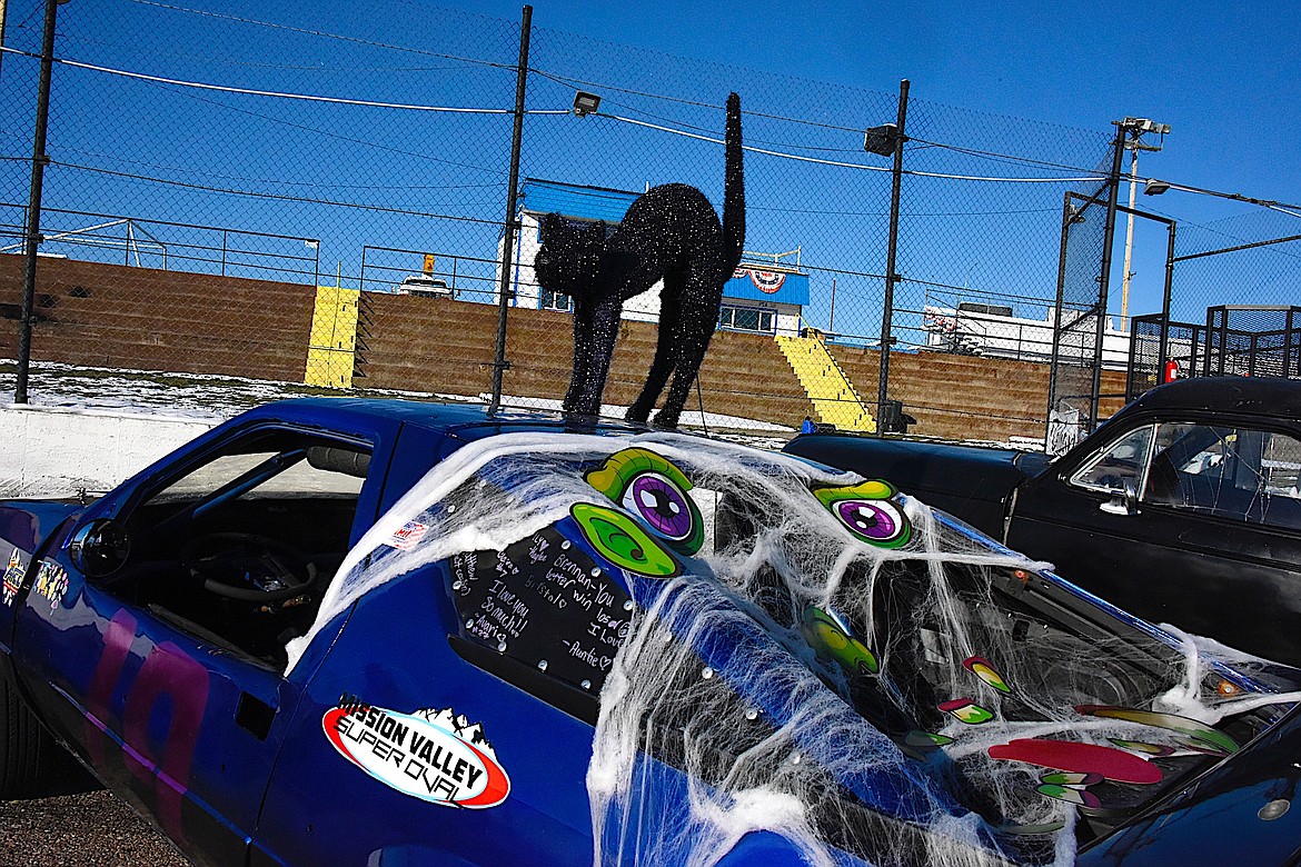 It wouldn't be Halloween without a black cat perched on a race car, giving kids and adults a fright. (Berl Tiskus/Leader)