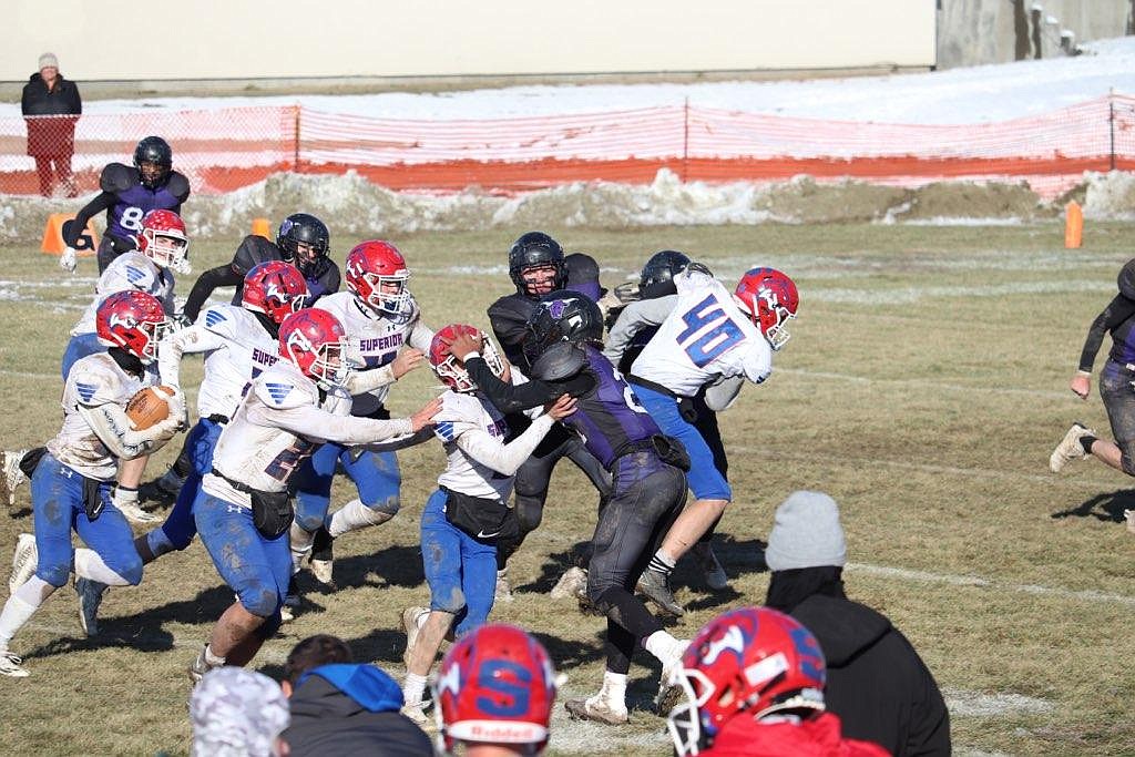 A wall of Bobcats blockers lead the way for senior running back Lucas Kovalsky during their playoff game versus Forsyth Saturday.  Superior won 54-20 to advance to the second round, a game this coming Saturday in Fort Benton.  (Photo by Kami Milender)