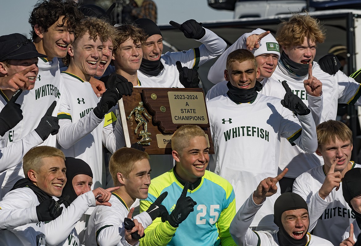 The Whitefish boys soccer team celebrates with the 2023 State A championship trophy after defeating Billings Central 1-0 on Saturday, Oct. 28 in Billings. (Amy Nelson/Billings Gazette)