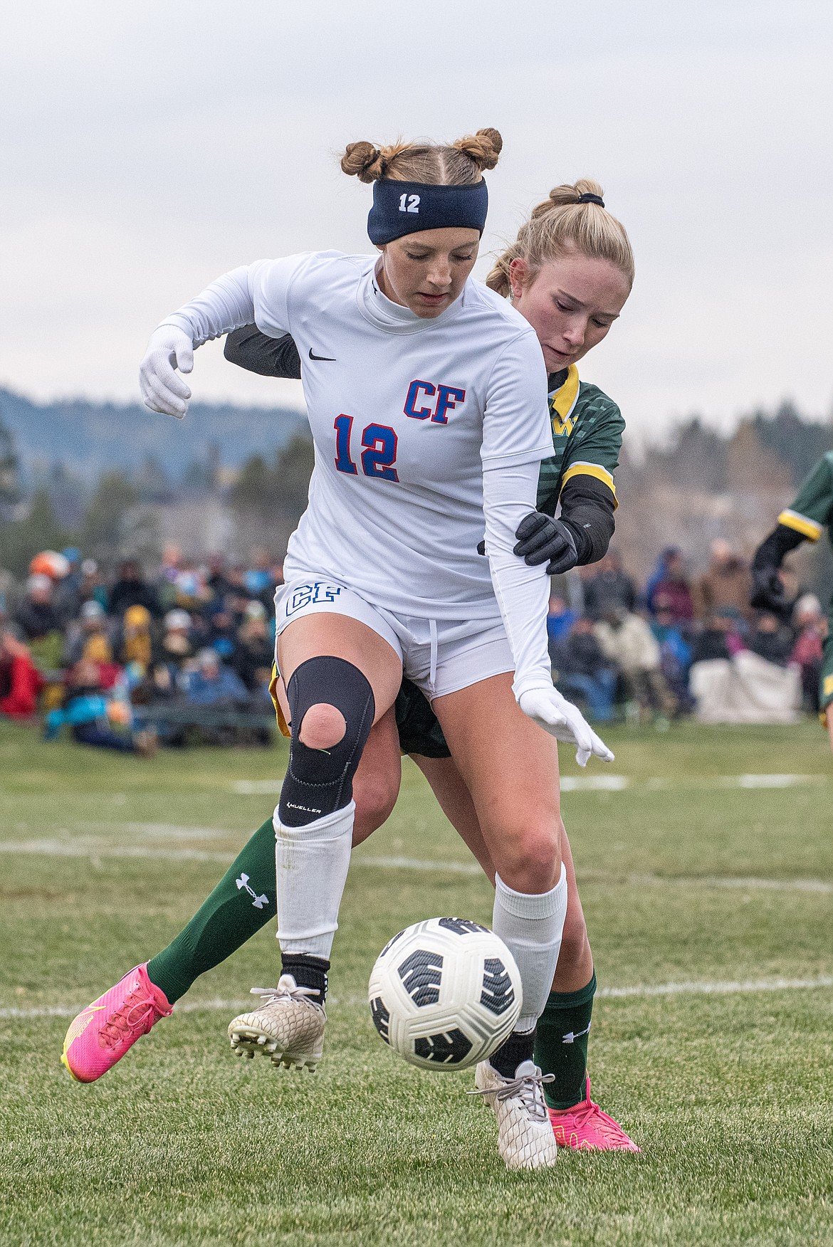 Wildcat Josie Harris maintains control of the ball as Bulldog Madison Gordon puts on the pressure in the Montana A girls championship soccer game on Saturday, Oct. 28 in Whitefish.