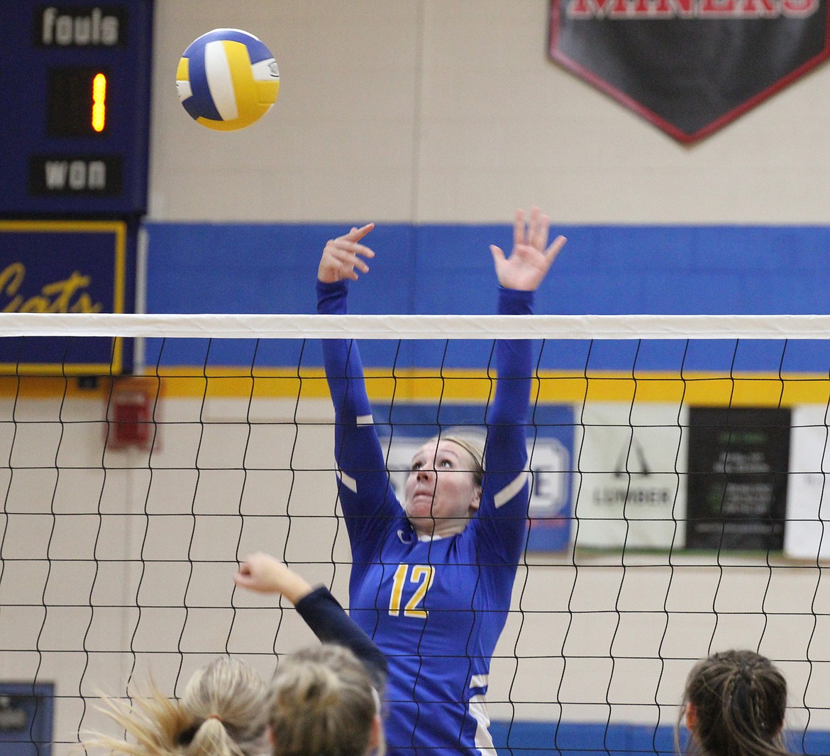 Clark Fork middle blocker Amari Printz-Hay reaches high in the air, attempting to block a hit in a game earlier this season against Genesis Prep Academy.