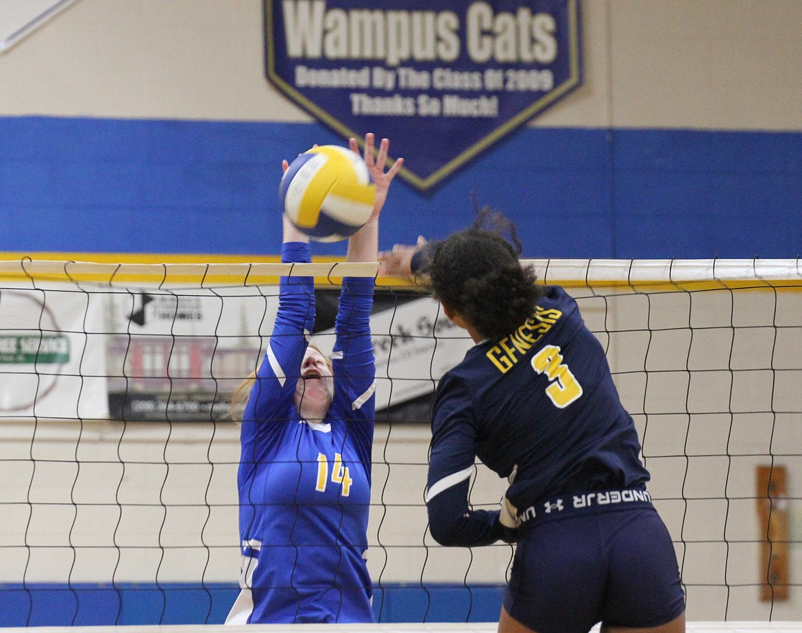 Clark Fork middle blocker Amie Matteson blocks a hit from Genesis Prep's Laya Daniel in a game earlier this season.