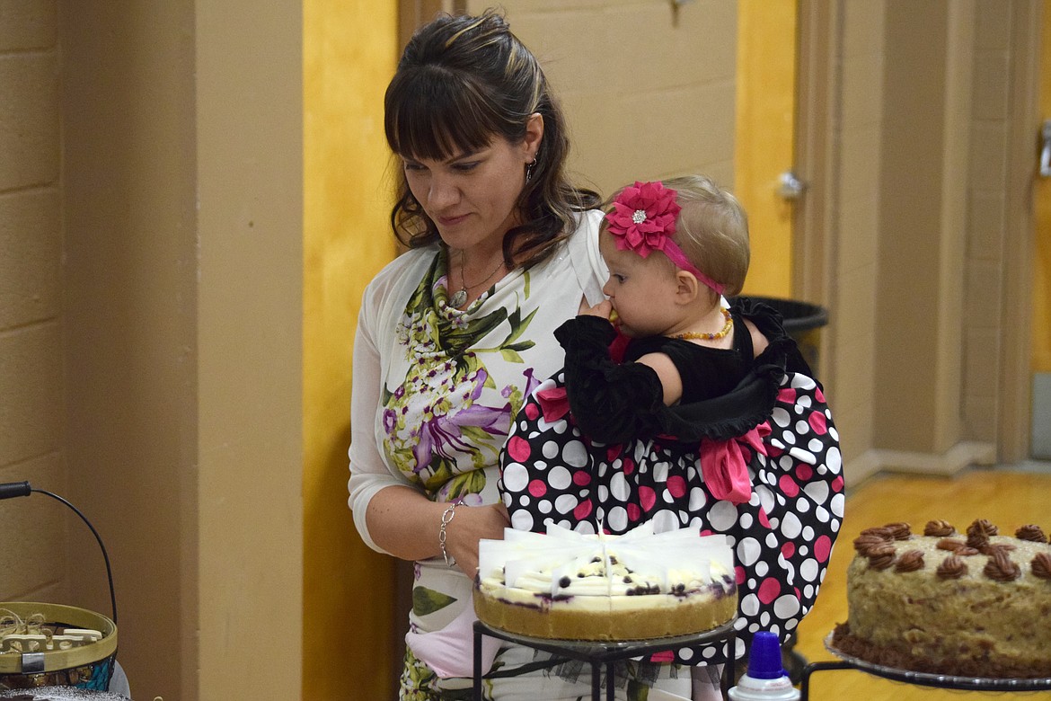 Attendees at a previous St. Rose of Lima auction check out the options at the dessert table. This year’s auction, the 40th, is Nov. 11.