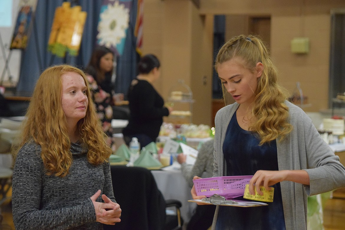 Volunteers get ready to distribute raffle tickets at a previous St. Rose of Lima Catholic School auction. The auction Nov. 11 will include several raffles, organizers said.