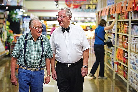 In fall 2010, Mayor Ron McIntire chats with customer Darwin Grant at his Super 1 Foods in Hayden.