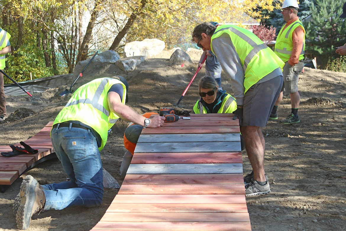 Pend Oreille Pedalers volunteers work to install features at the Tiny Woods bike skills course in late October.