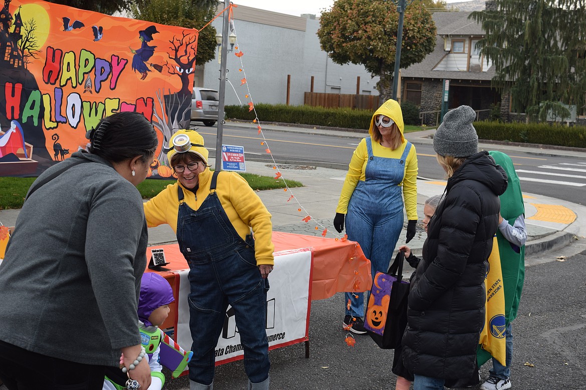 Rita Witte, director of the Ephrata Chamber of Commerce, hands out candy to a happy Buzz Lightyear. She and her fellow minion Suzy Anderson, one of the chamber’s board members, worked to help ensure city residents and businesses could get together and have a good time for the spookiest holiday of the year.