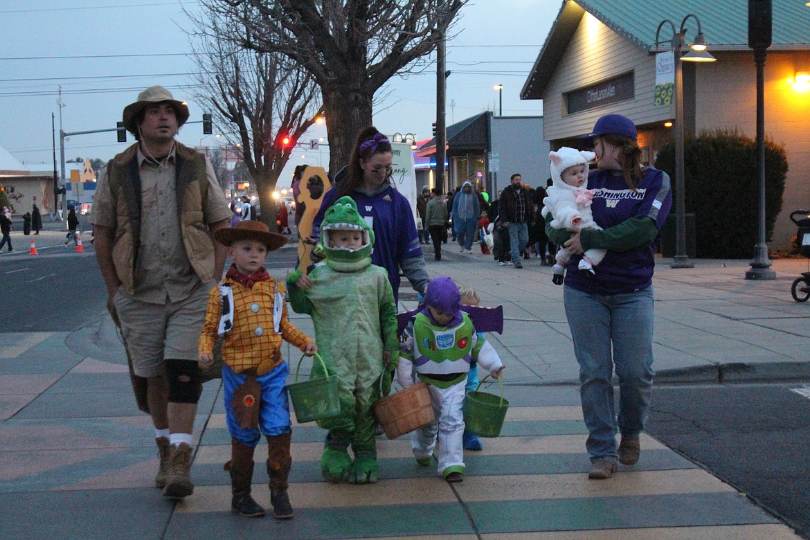 Cartoon characters, a dinosaur and lamb (and an outback Dad) cross Central Avenue North in search of candy.