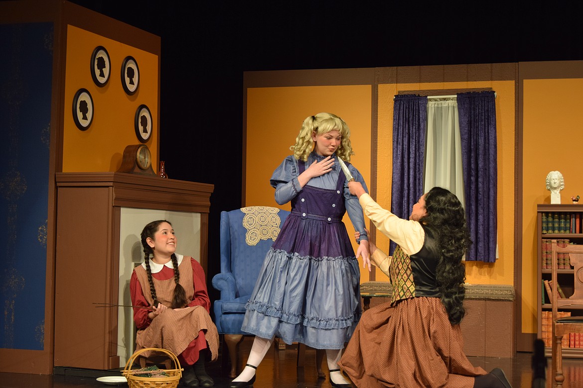 Jo March (Magali Marroquin), right, has cast herself in the role of villain and her sister Amy (Karli Long), center, as the threatened heroine, while sister Beth (Gisele Vazquez) watches. The Othello High School production of “Little Women” is on stage tonight and Saturday night.