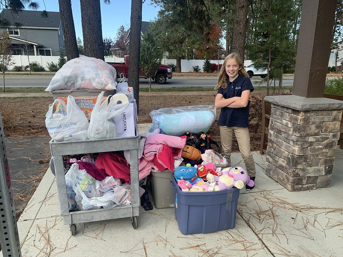 Sixth grader Ari Leferink poses with the loot she gathered from a donation drive in her neighborhood for the Children's Village.