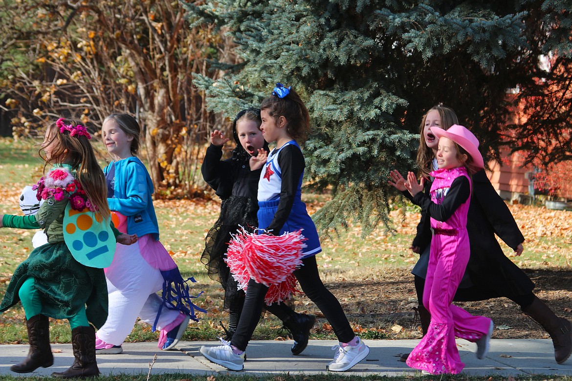 Washington Elementary students walk near the school as part of the school's annual Halloween Parade on Tuesday.