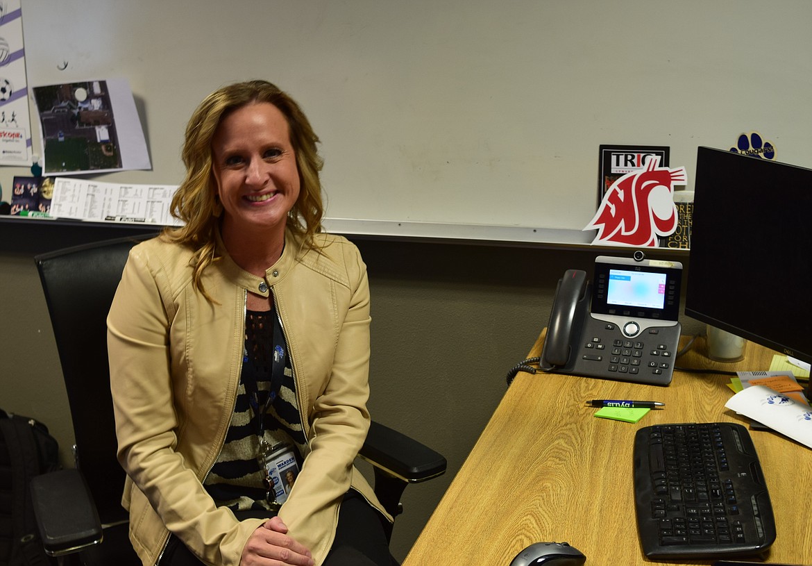 Warden High School Principal Katie Phipps sits at her desk in front of a Washington State University logo. Phipps said she is a graduate of WSU.