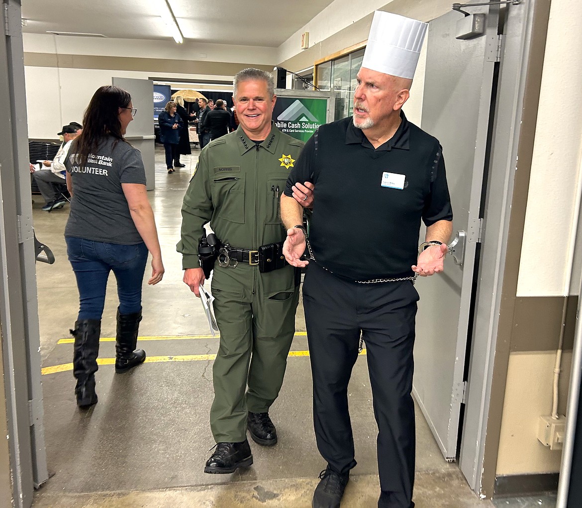Kootenai County Sheriff Bob Norris and St. Vincent de Paul Executive Director Larry Riley have some fun at the at the "Souport The End of Homelessness" fundraiser for St. Vincent de Paul North Idaho at the Kootenai County Fairgrounds on Thursday.