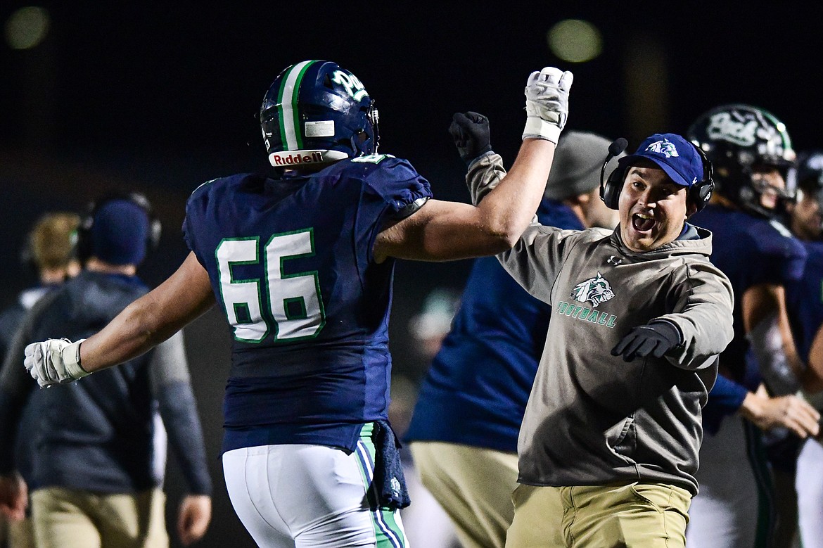 Glacier offensive line coach Connor Fuller celebrates with Henry Sellards (66) after a touchdown in the third quarter against Missoula Sentinel in the quarterfinals of the Class AA playoffs at Legends Stadium on Friday, Nov. 3. (Casey Kreider/Daily Inter Lake)