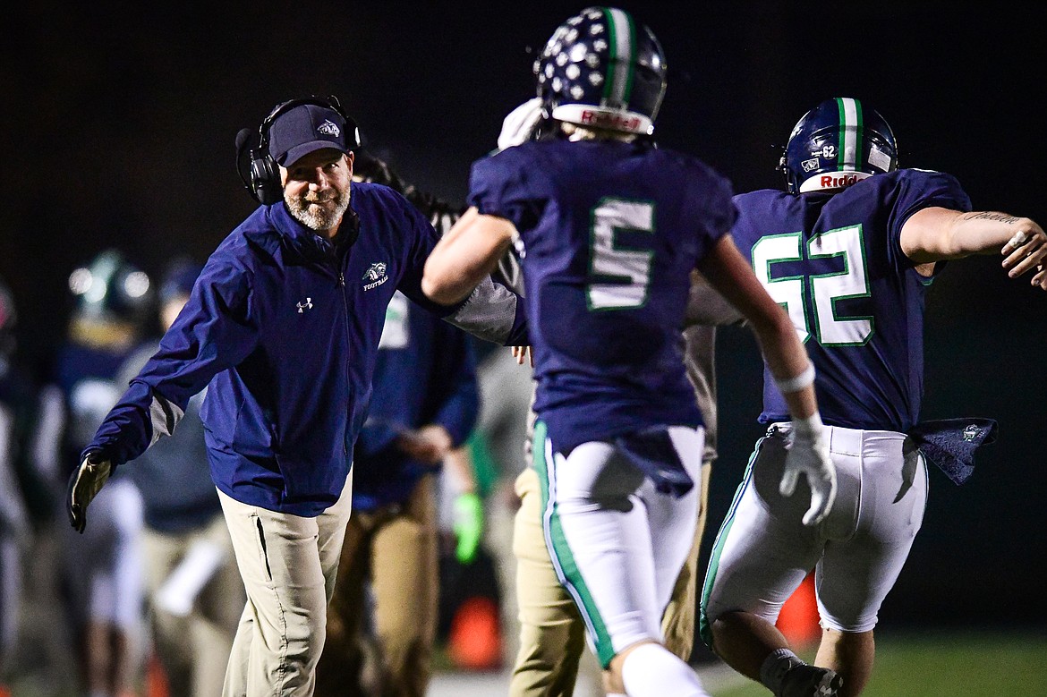 Glacier head coach Grady Bennett congratulates Bridger Smith (5) and TJ Gannon (62) after a touchdown in the fourth quarter against Missoula Sentinel in the quarterfinals of the Class AA playoffs at Legends Stadium on Friday, Nov. 3. (Casey Kreider/Daily Inter Lake)