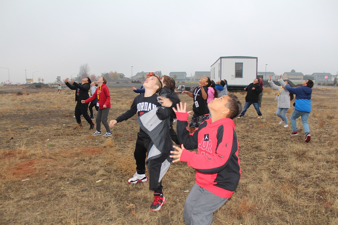 Fifth graders try to catch fries launched by CB Tech students.