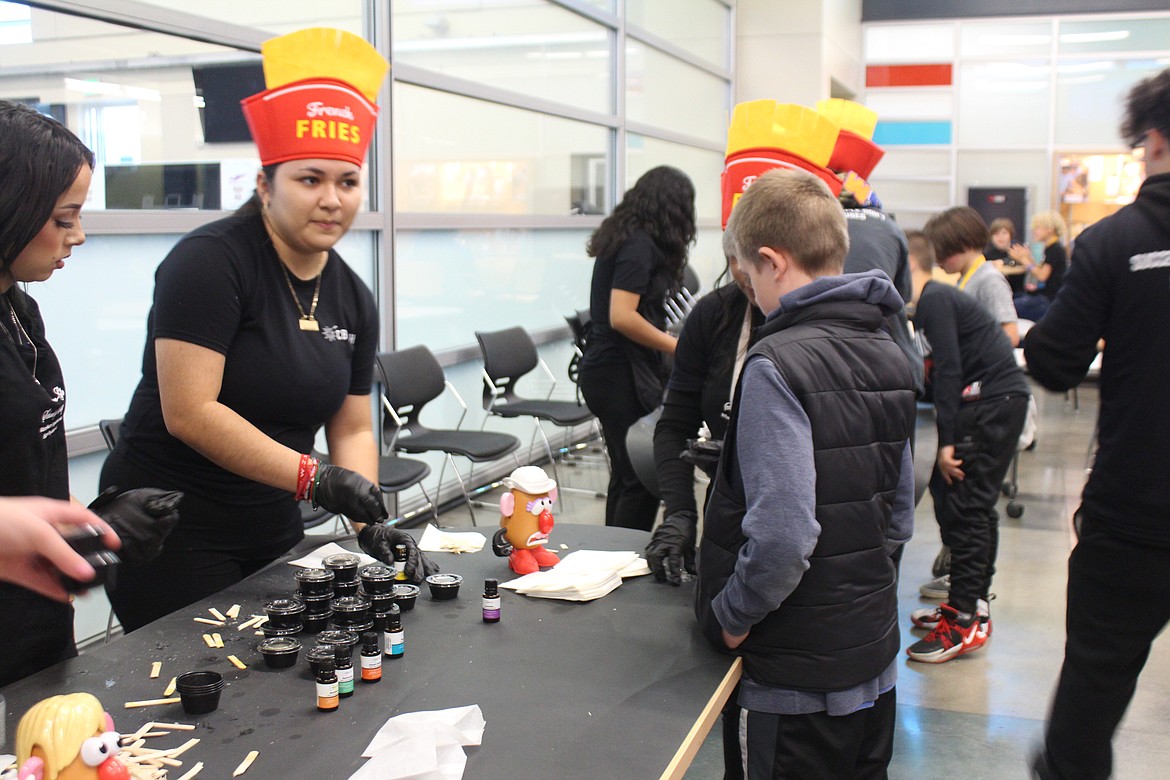 Cosmetology students use a potato-based exfoliant to give fifth graders a lesson in skin care.