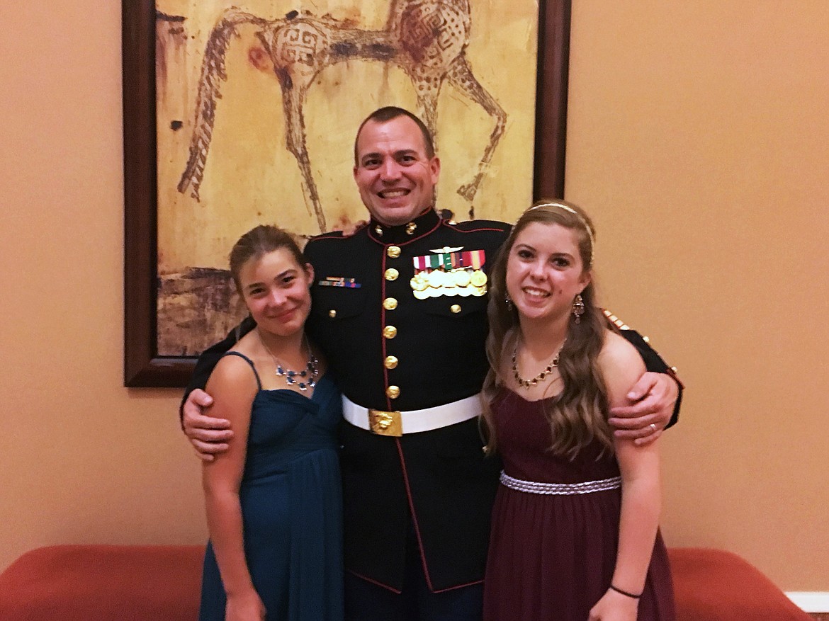 Jeremy Gaffield, who served in the United States Marine Corps, is pictured with his daughters.