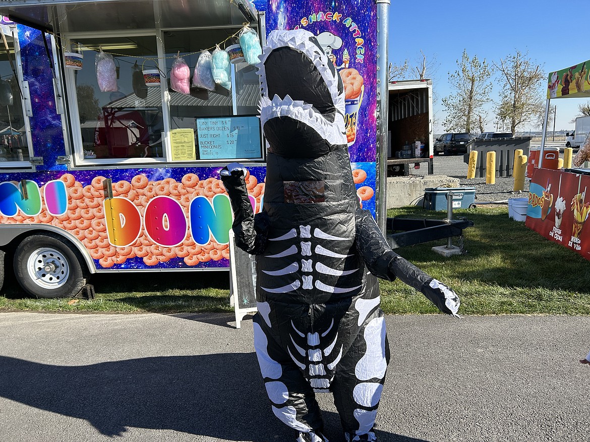 People attending the festival such as this skeleton T-rex were encouraged to dress up in costume to celebrate.