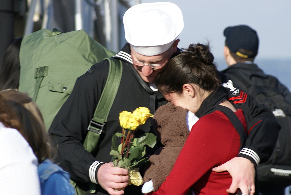 Dustin Woelfle is pictured with his family at the end of a seven-month deployment.