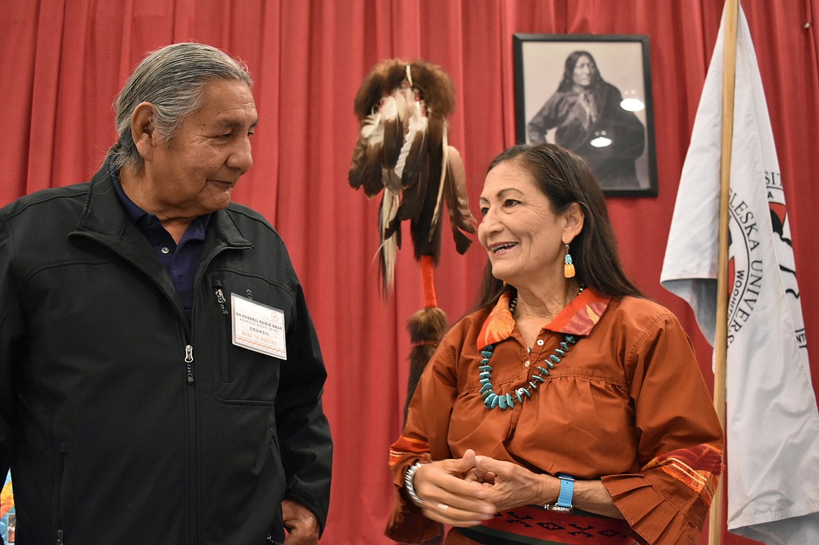 Russell Eagle Bear, with the Rosebud Sioux Reservation Tribal Council, talks to U.S. Interior Secretary Deb Haaland during a meeting about Native American boarding schools at Sinte Gleska University in Mission, S.D., Saturday, Oct. 15, 2022. Haaland plans to be in Bozeman, Mont. Sunday to wrap up her nationwide tour confronting the legacy of the institutions where students were often abused. (AP Photo/Matthew Brown, File)