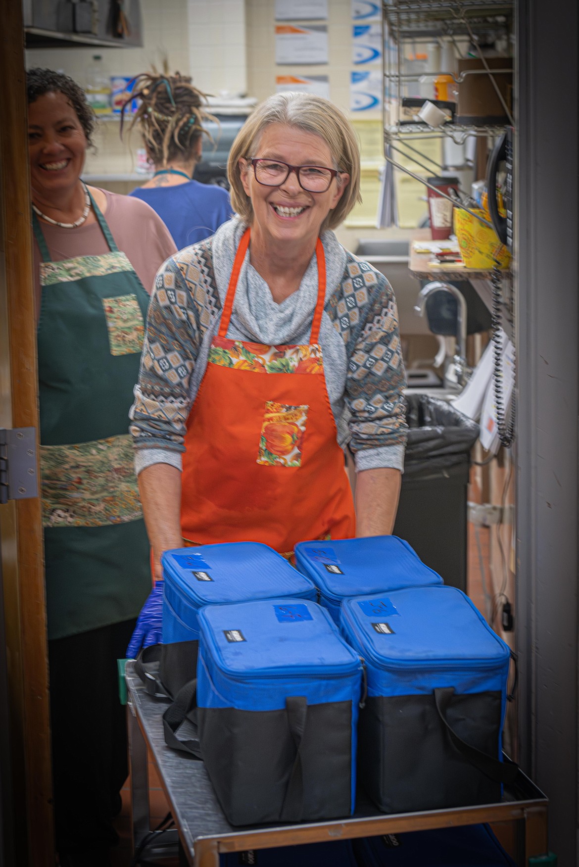 Jeanine Cook makes snacks for the students. (Tracy Scott/Valley Press)