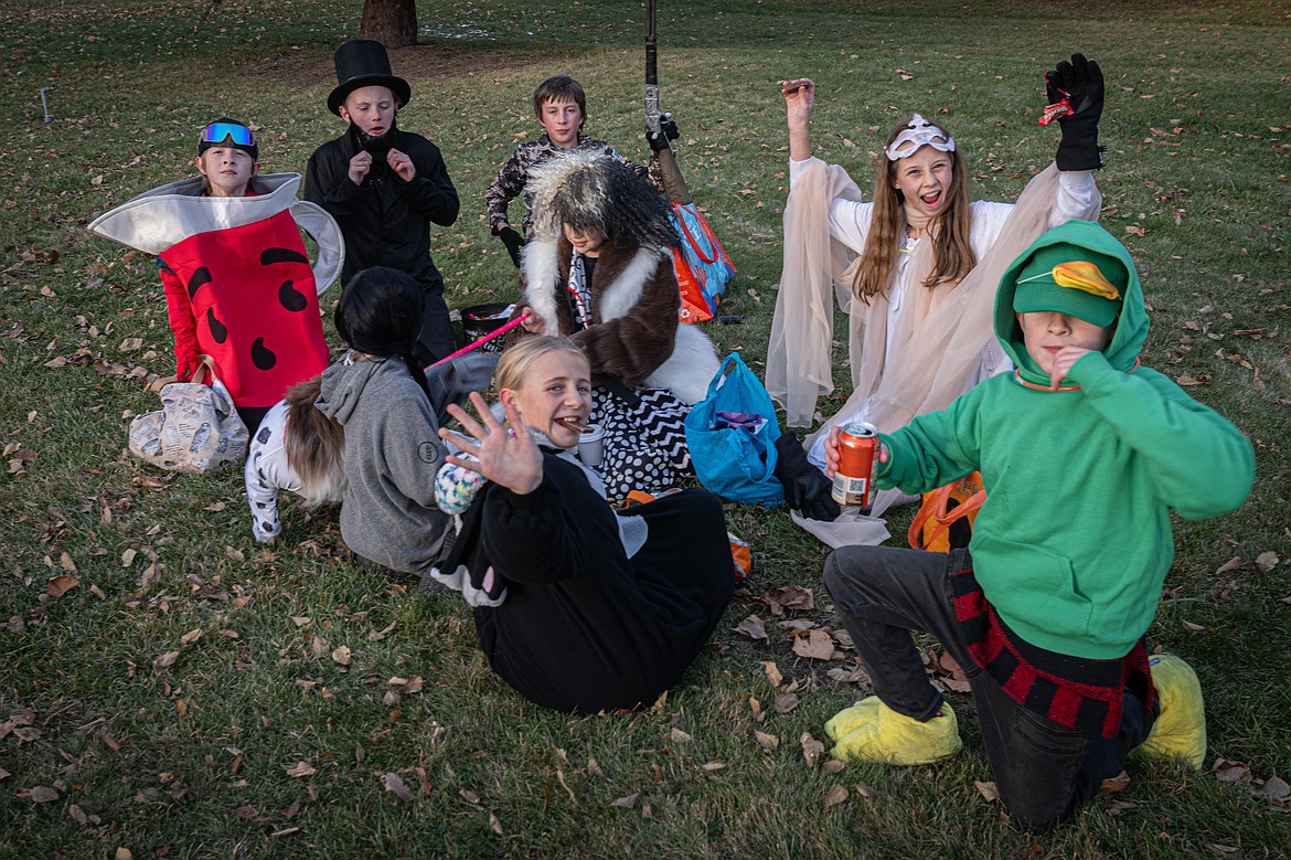 Trick or treaters count their stash of candy at Fred Young Park. (Tracy Scott/Valley Press)