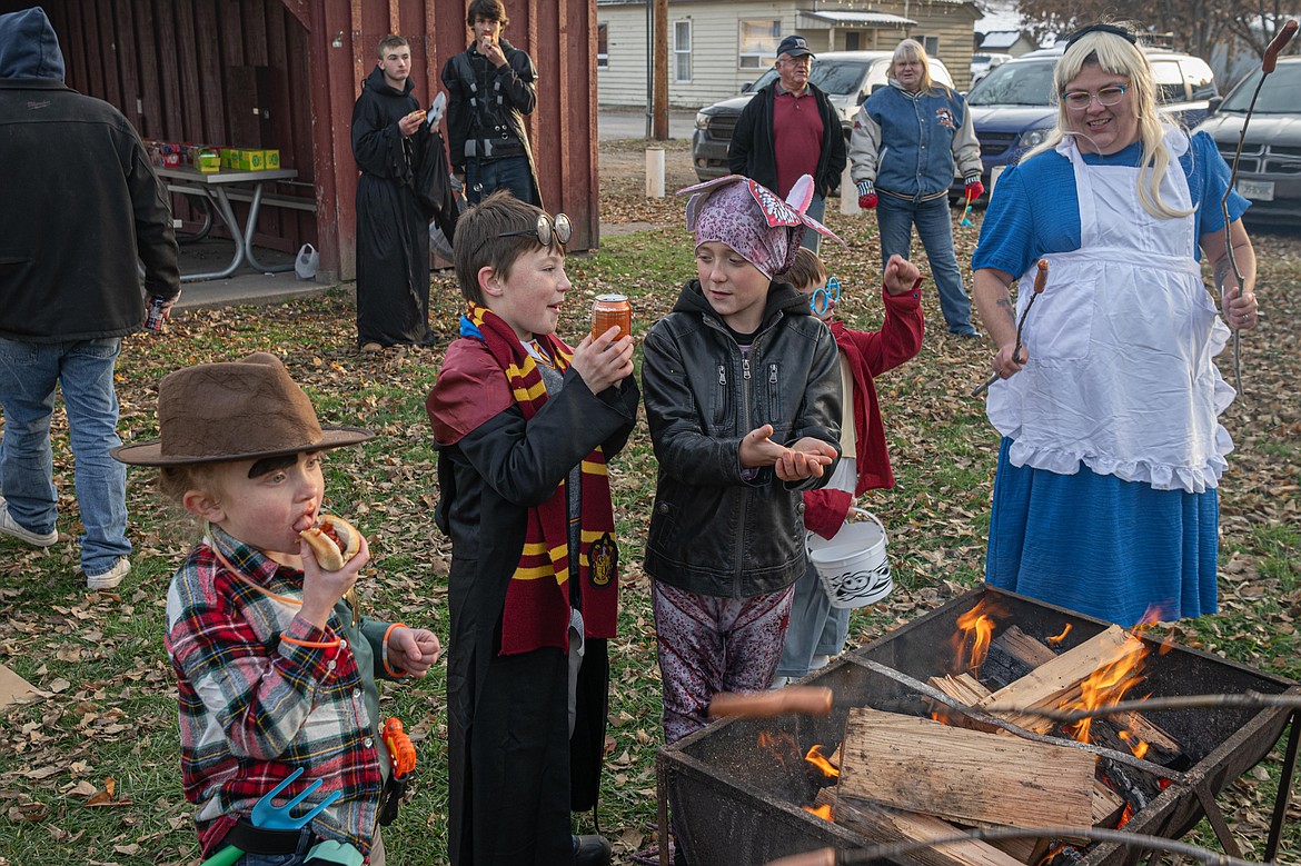 Trick or treaters get their fill at the hotdog roast sponsored by the Plains Lion Club. (Tracy Scott/Valley Press)