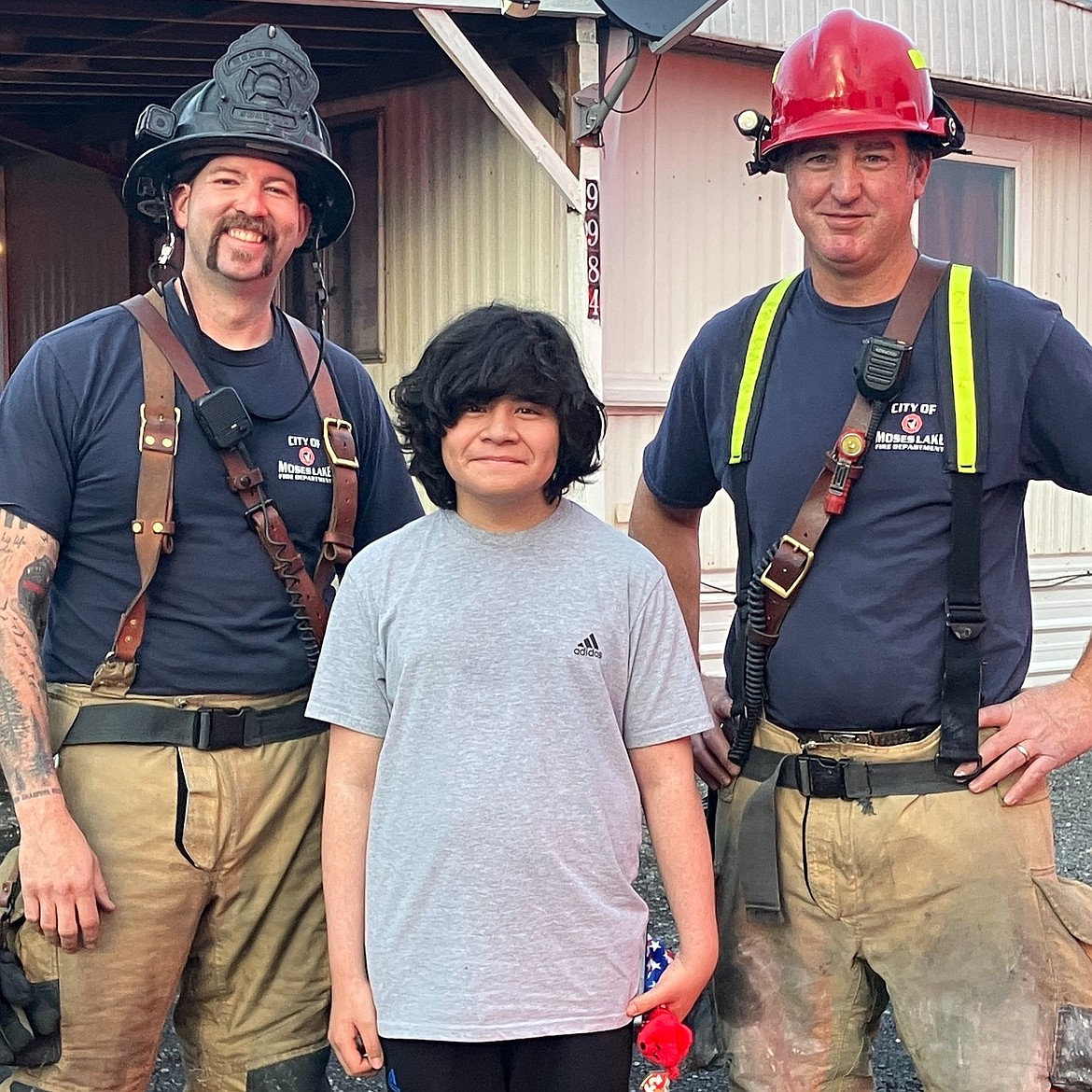 Eleven-year-old Isaac Rodriguez, center, very likely saved his family’s home from a fire Monday by thinking quickly and knowing how to respond, Moses Lake firefighters said.