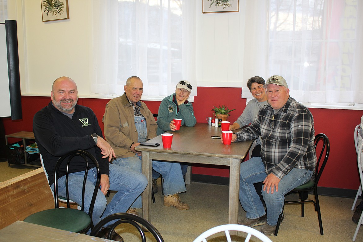 From left is Mark Quinn, George and Liz Gupton, and Heather and Wade Gooden. The Quinns and Goodens recently purchased the Old Superior School from the Guptons and were introduced at the Mineral County Chamber of Commerce meeting. Old Bull Brewing in Frenchtown is owned by the Goodens and Quinns, so they brought several growlers of their signature beers to the celebration. (Monte Turner/Mineral Independent)