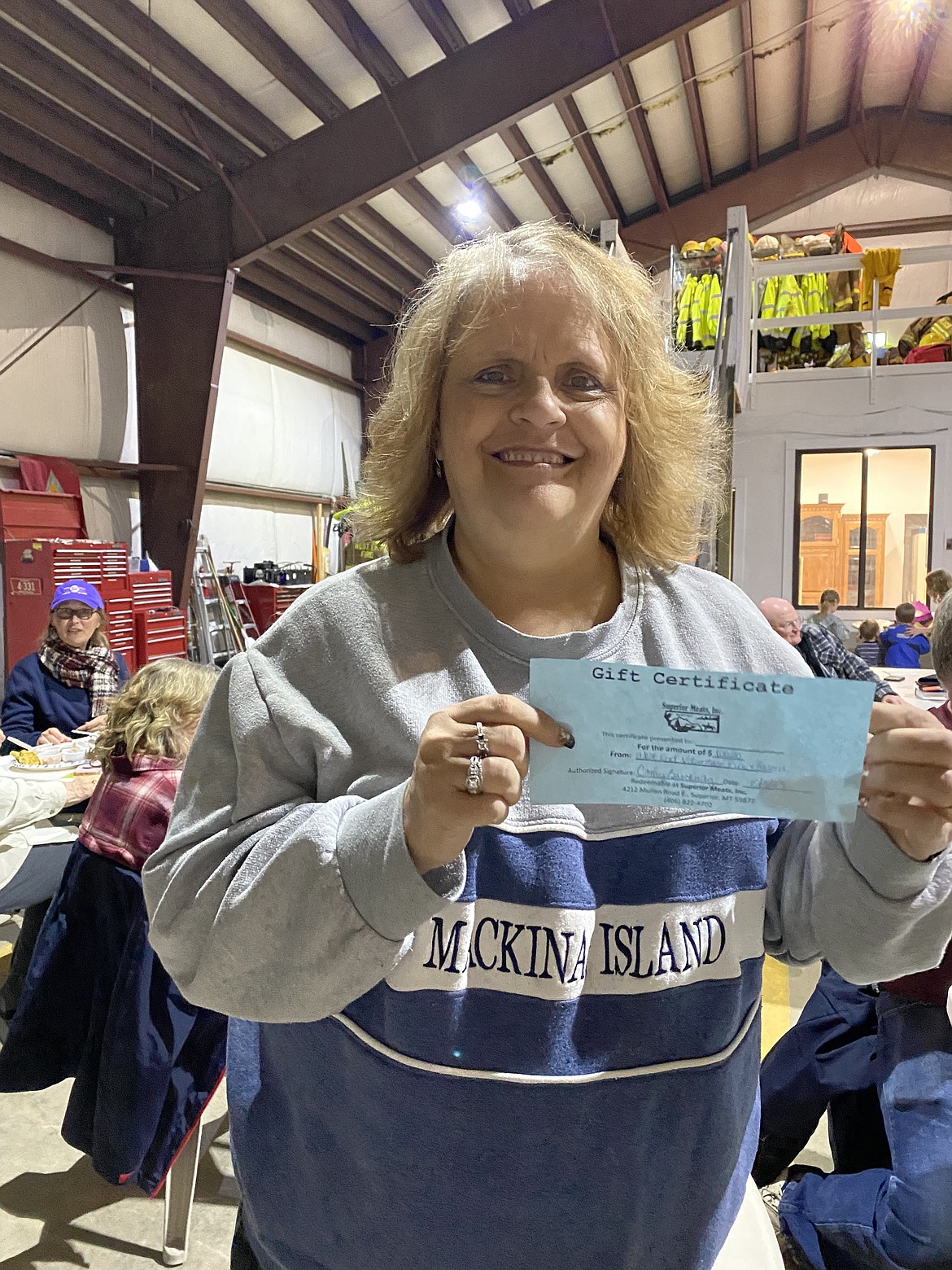 Naomi Mesenbrink holding the $50 gift card from Montana Bar in Saltese she won at the WEVFD Chili Cookoff last Saturday. Around 50 people attended and supported the organization. (Photo by Susan Charles)