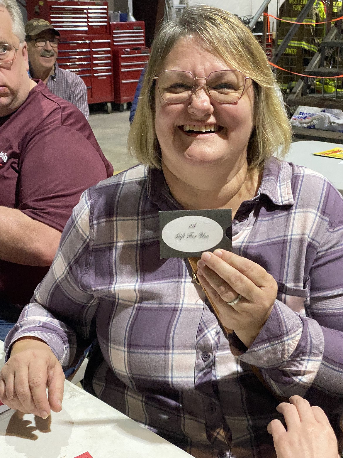 Phyllis Stevens smiles after receiving a $100 gift card for Superior Meats. (Photo by Susan Charles)