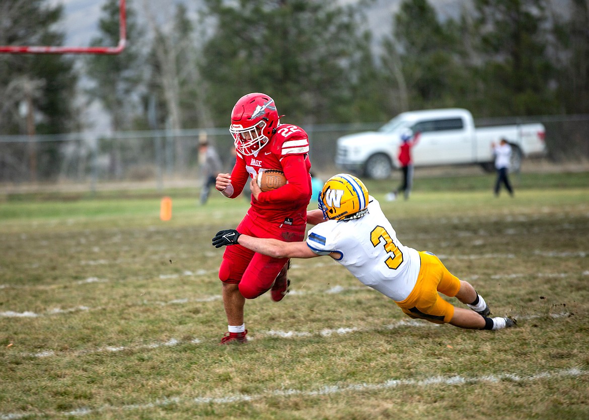 Warrior Jace Arca tries to evade Fairview tackle during recent quarterfinal playoff game in Arlee. (Jamie Sievers photo)