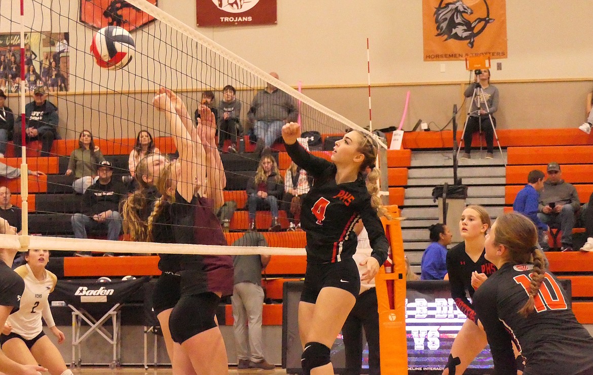 Plains senior Marissa Young (4) swats at a Florence-Carlton shot during their first round match of the Western B Divisional volleyball tournament in Eureka this past week. (Chuck Bandel/VP-MI)