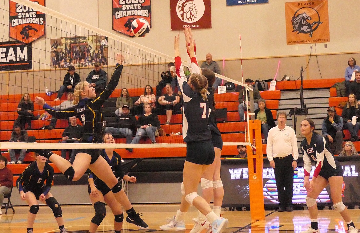 Thompson Falls sophomore Gabi Hannum tips back a shot by a Loyola player during first round action of the Western B Divisional volleyball tourney last week in Eureka.  (Chuck Bandel/VP-MI)