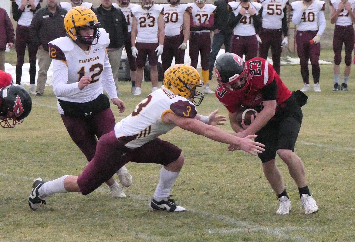 Harlowton defender Bergen Mysse tackles Hot Springs running back Johnny Waterbury in first quarter action from their six-player quarterfinal playoff game Saturday in Hot Springs. (Chuck Bandel/VP-MI)