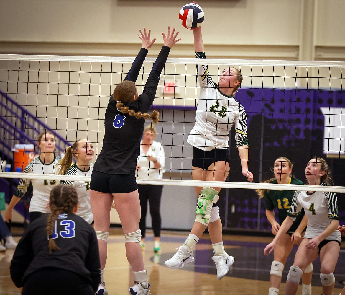 Brooke Zetooney soars above the net to make a play against Corvallis blocker Meredith Buhler during action at the Western A Divisional Volleyball Tournament in Polson Thursday. (Jeremy Weber/Bigfork Eagle)