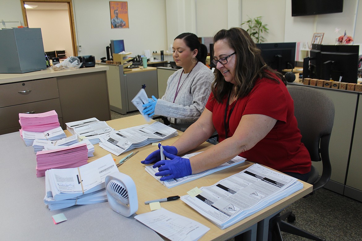 Aleanah Lopez, left, and Robin Rutty open ballots at the Grant County Auditor’s Office Tuesday afternoon.