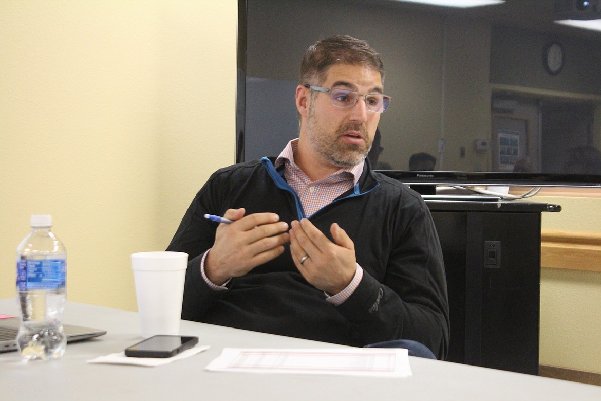 Abram Jenks, one of the project managers for the new Quincy hospital, reviews the construction contract during a special board meeting.