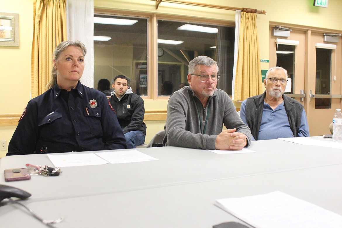 Quincy Valley Medical Center board members, from left, Michele Talley, Randy Zolman and Bob Poindexter listen to a presentation Monday on the construction contract for the new hospital.