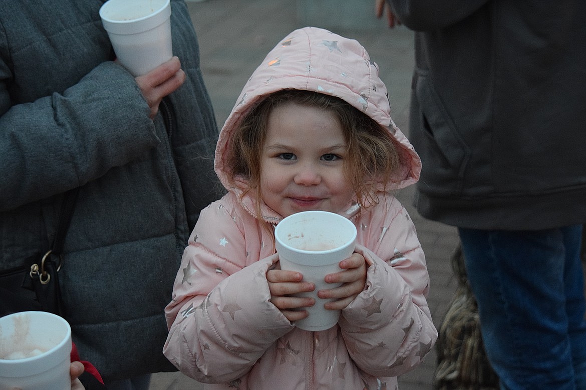 Ruth Gladieux-Smith, 4, savors her hot chocolate as she waits with her family in Sinkiuse Square during the 2022 annual Moses Lake Tree Lighting. This year’s event will also be in Sinkiuse Square Friday from 4 to 6 p.m.