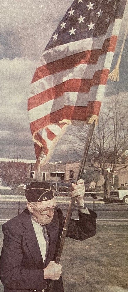 World War I veteran Gordon Needham, 90, carries the flag at 1988 Veterans Day ceremonies.