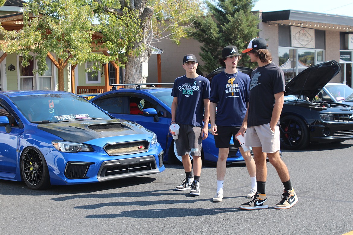 Spectators look over some of the cars at the MLCCC show during September’s Sip ‘n Stroll in Moses Lake.