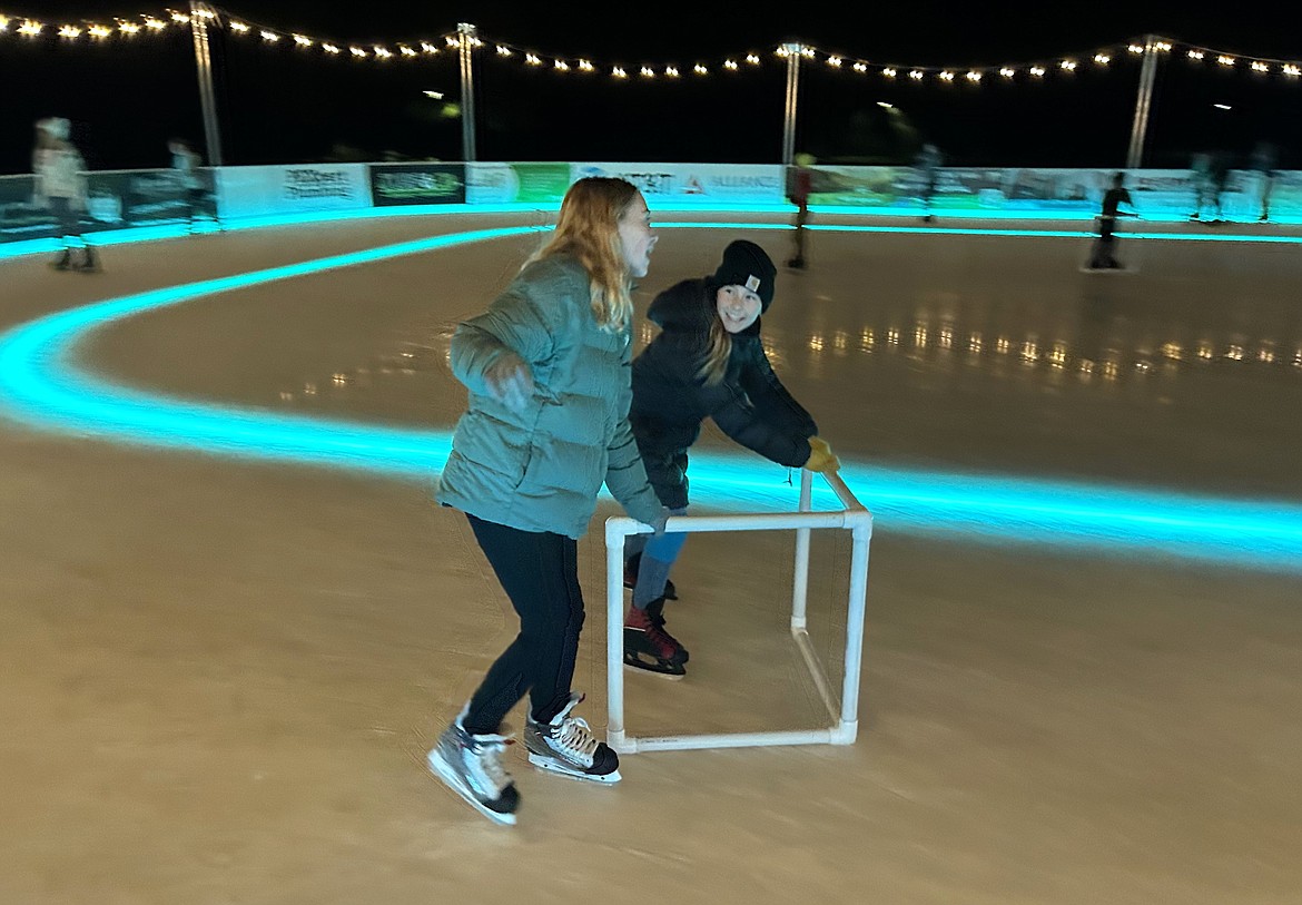 Skaters get a little help with a walker at Coeur d'Alene on Ice at McEuen Park on Wednesday. The ice rink is open daily into January.