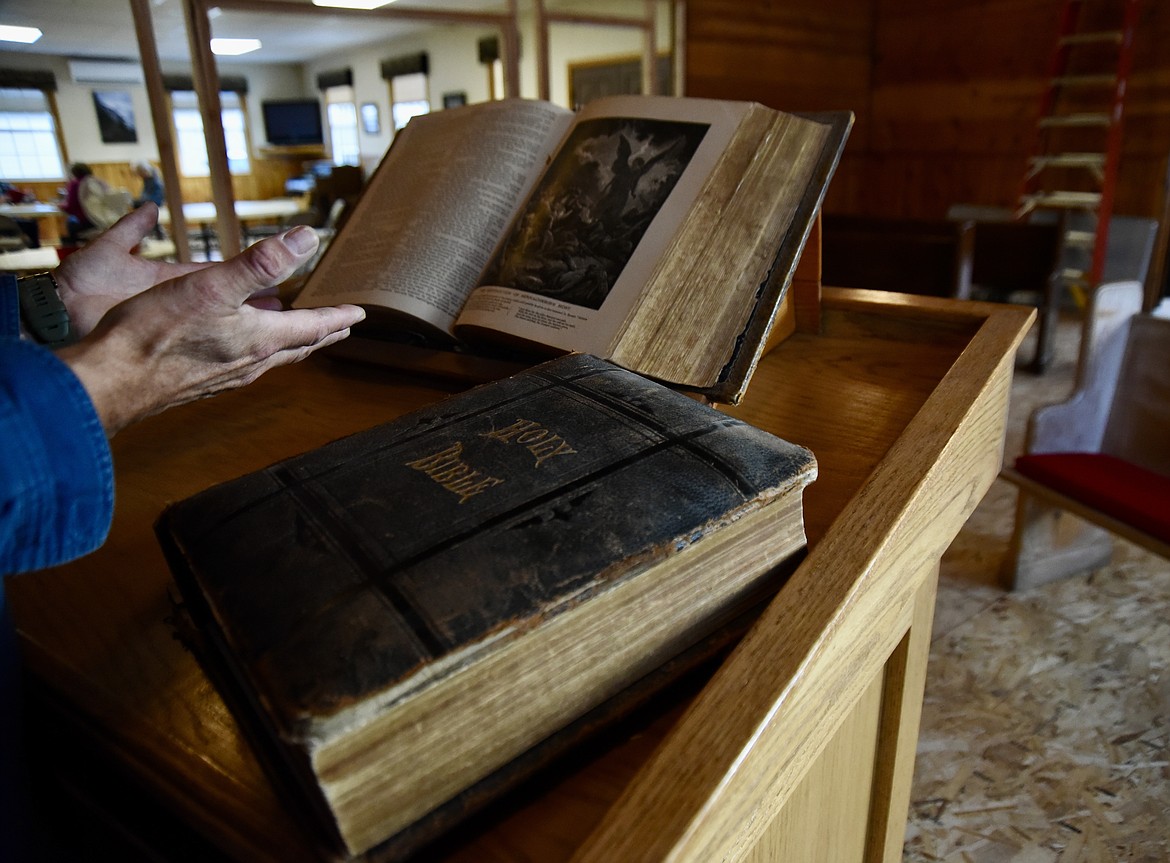 Lakeside Community Chapel board of trustees chairman Sam Bagley shows two antique Bibles at the church Saturday, Oct. 23, 2023. The Bibles have since been sent to Missoula to be rebound. (Hilary Matheson/Daily Inter Lake)