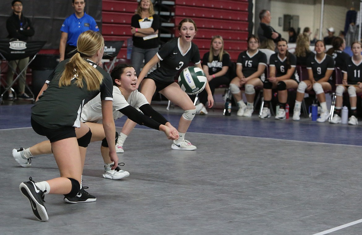 ACH freshman Grace Okamoto, in white, dives down to save a ball against Mount Vernon Christian on Wednesday in the 1B State Volleyball Tournament.