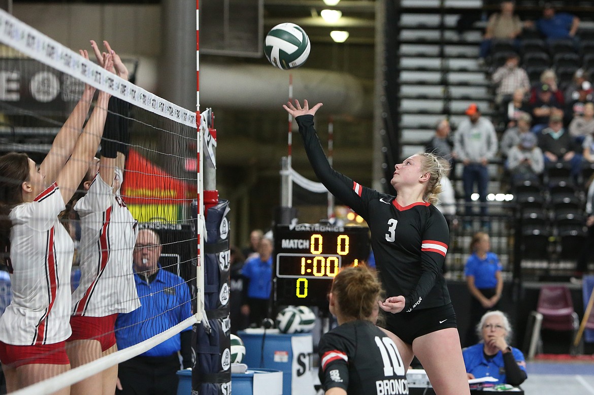 LRS junior Addy Colbert (3) tips the ball over the net during the Broncos’ first-round match against Copueville on Wednesday.