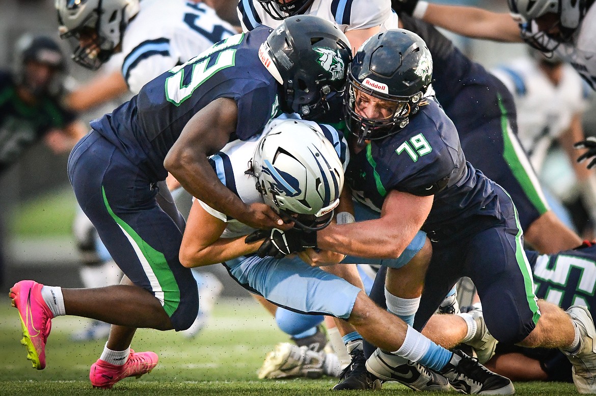 Glacier defenders Aiden Krause (79) and Kobe Dorcheus (33) sack Great Falls quarterback Riley Collette (11) in the first half at Legends Stadium on Friday, Aug. 25. (Casey Kreider/Daily Inter Lake)