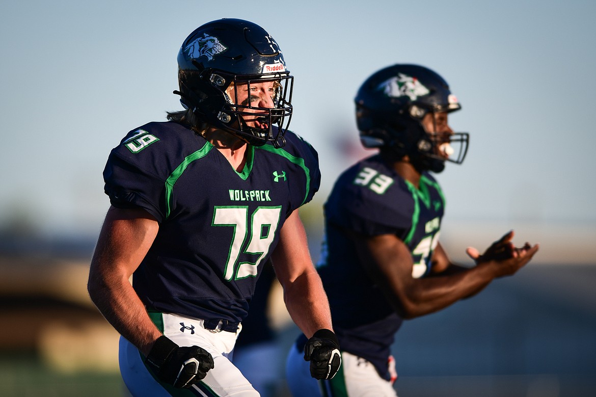 Glacier's Aiden Krause (79) and Kobe Dorcheus (33) celebrate after a defensive stop in the first quarter against Helena at Legends Stadium on Friday, Sept. 15. (Casey Kreider/Daily Inter Lake)